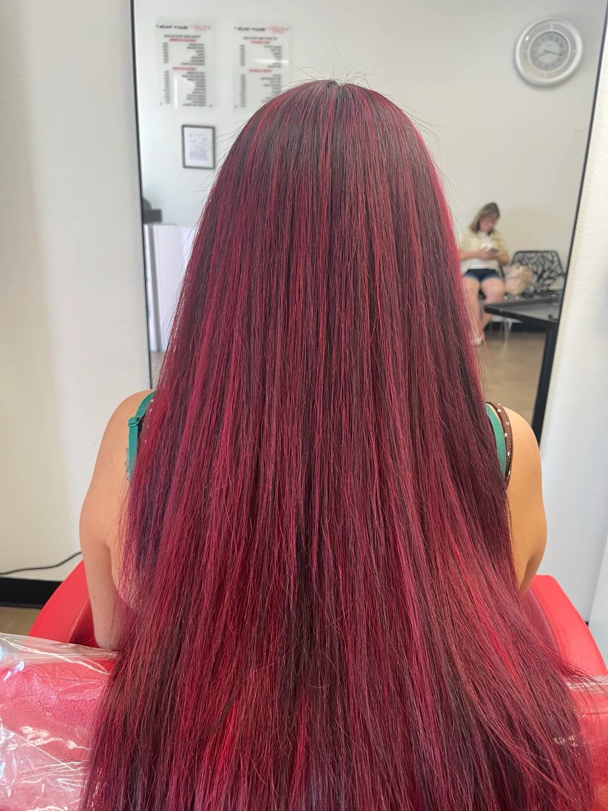A vivid red color carried the full length of long straight hair