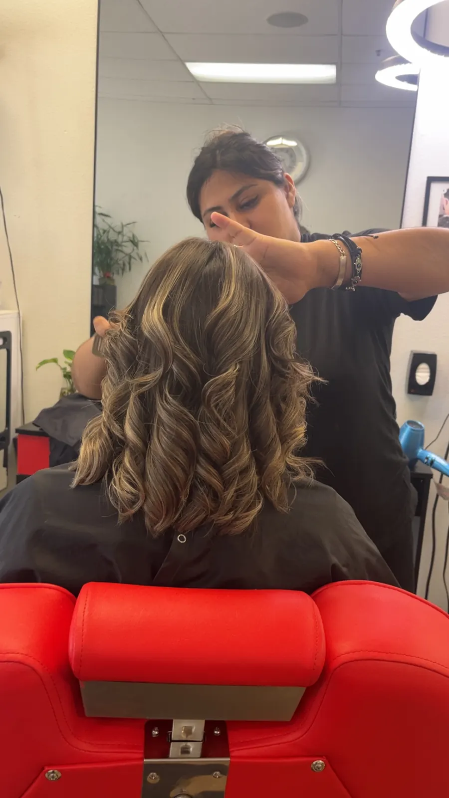 Soft bronde curls being set at the styling chair